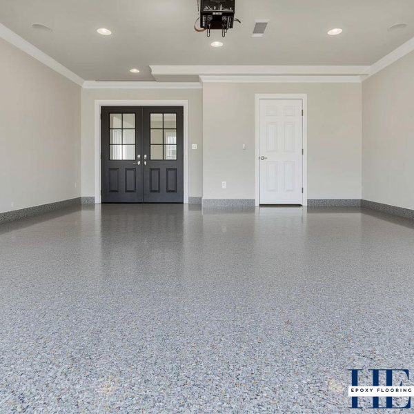 Wide shot of a clean, seamless decorative flake epoxy garage floor in a high-value Niddrie residence.