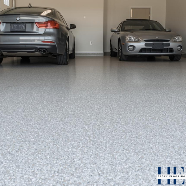 Finished durable epoxy flake floor resisting stains and wear in a Delahey residential garage.