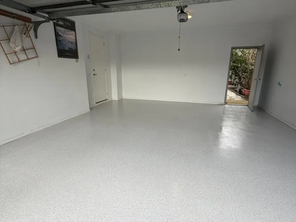Warm grey non‑slip epoxy flake garage floor in Sydenham near a laundry door