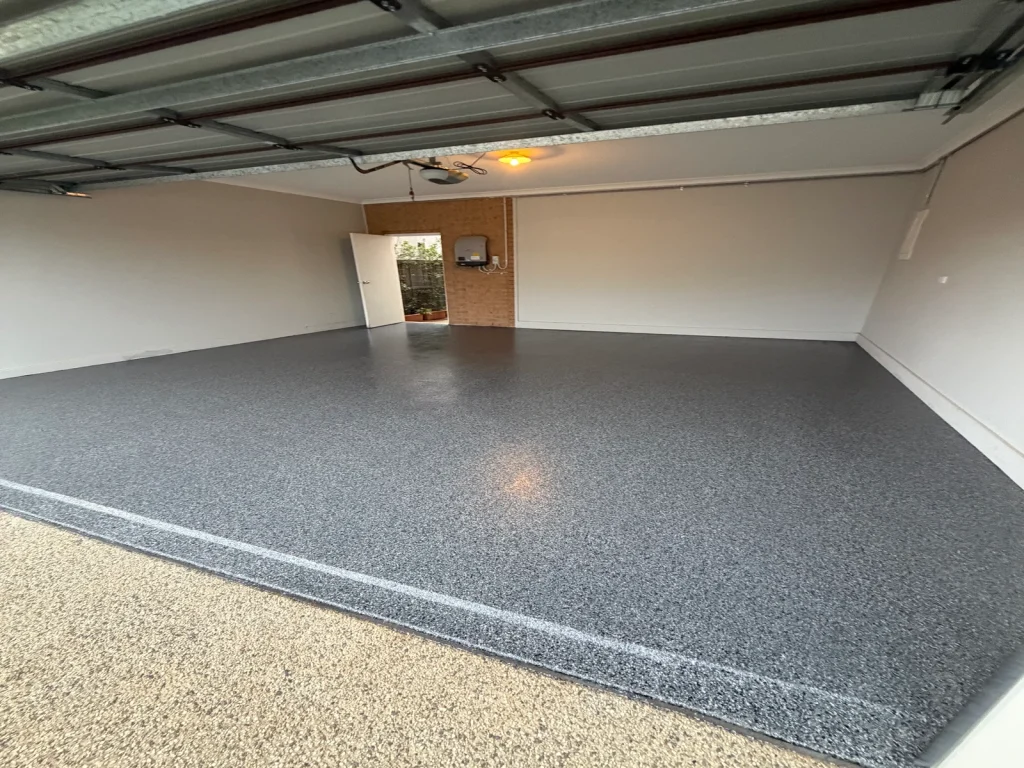 Glossy charcoal epoxy flake showroom garage floor in Taylors Lakes with cars parked inside